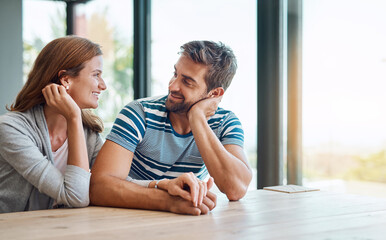 Conversation, couple and holding hands in home for marriage, together and morning in living room. Love, support and man with woman for chat, care and security or discussion in house or apartment