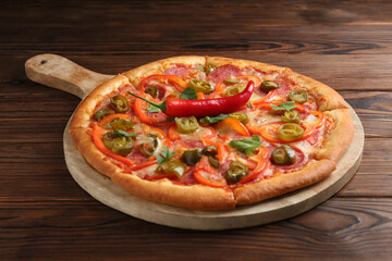Delicious hot pizza Diablo on wooden table