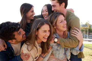 Fototapeta premium a group of young people are hugging each other in a park . High quality