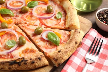 Delicious vegetarian pizza served on wooden table, closeup