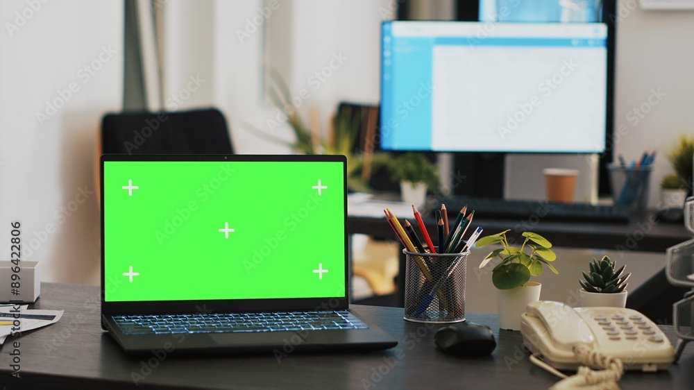 Poster office with green screen laptop and display in background with clients appointment list, panning sho