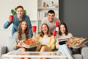 Group of young friends with beer and pizza at home party