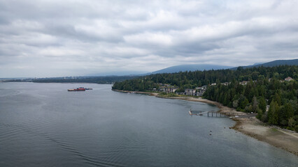 Aerial View of shore, trees and mountains in North Vancouver