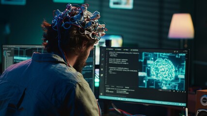 Computer scientist puts EEG headset on, starting mind upload process, trying to gain bionic powers....