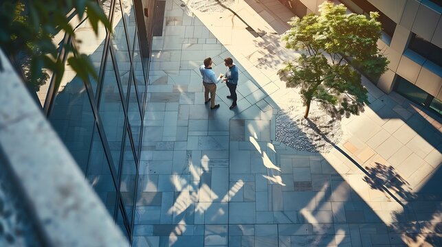 View from above business people talking in architectural modern office atrium courtyard : Generative AI