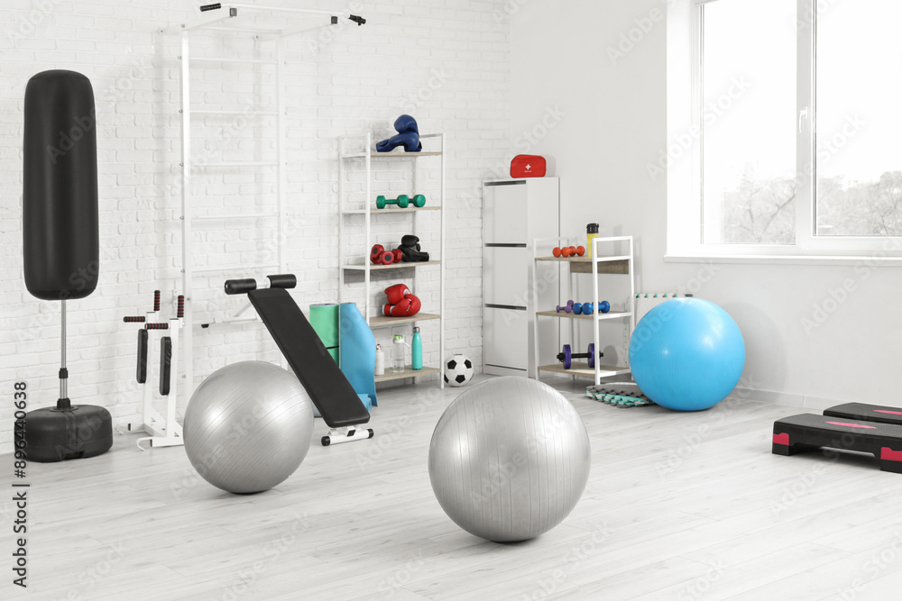 Poster Interior of modern gym with sports equipment and shelf units