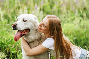 Portrait woman and her best Alabai friend  white dog in the park in summer