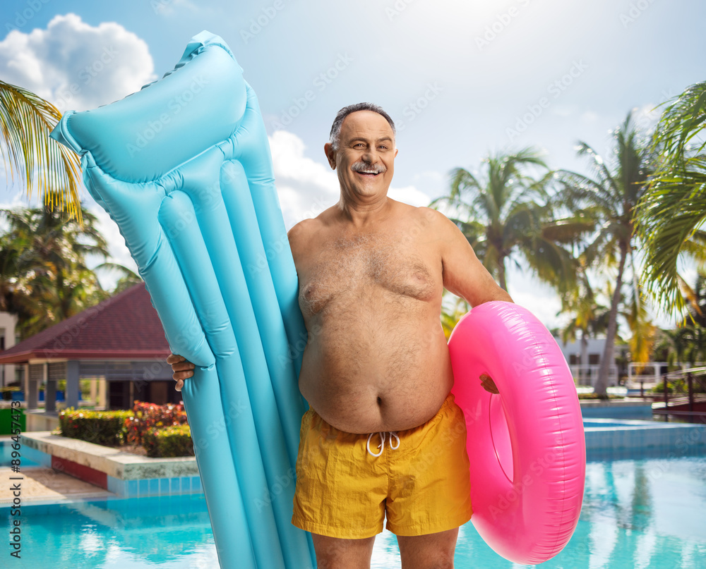 Canvas Prints man in swimwear on a summer holdiay with a mattress and swim ring at a pool