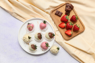 Plate with chocolate covered strawberries and wooden board of fresh berries on white background