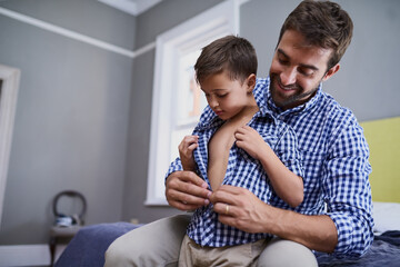 Dad, son and help getting ready in morning to start school with support, growth or development in...