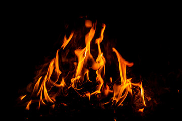 Fire flame background. Hell bonfire. Texture of fire on a black background. Blaze flames background for banner. Burning flames. Fire texture. © Korneliia