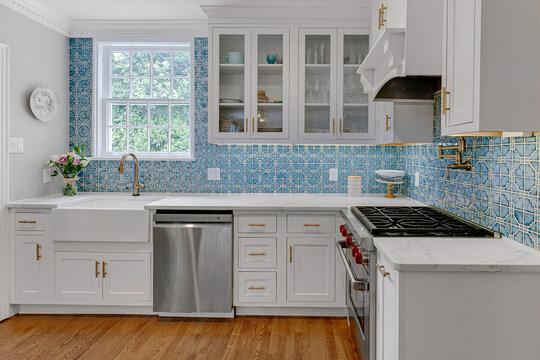 Beautiful Kitchen With Blue Tile Backsplash And Stainless Steel Appliances