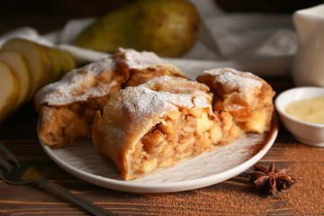 Plate with pieces of tasty pear strudel, closeup