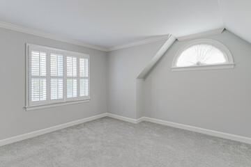 Bright And Clean Empty Room With White Shutters And Carpeted Flooring