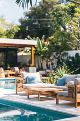 Obraz premium Outdoor pool area with modern furniture, surrounded by garden with plants and trees