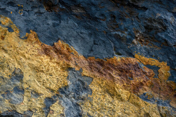 Macro photography of a black and golden rock texture, captured in a mountain of the eastern Andean...
