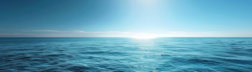 Fototapeta premium The ocean is calm and blue, with a bright sun shining on the water