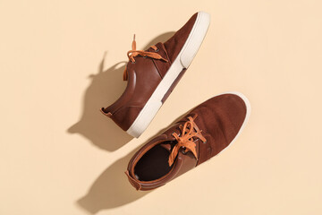 Stylish male brown shoes on beige background
