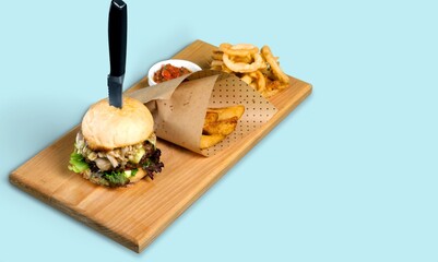Classic tasty hot cheeseburger on wood desk