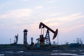 In the evening of oilfield derrick