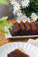 Kek Buah Kukus, a traditional Malaysian steamed fruit cake filled with dried fruits, nuts, and spices