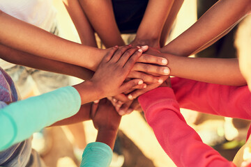 Stack of hands, group and children in circle for unity, collaboration or youth bonding together. Team, support and kid friends outdoor with solidarity, connection or motivation in nature for trust.