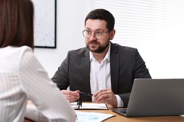 Fototapeta premium Consultant working with client at table in office