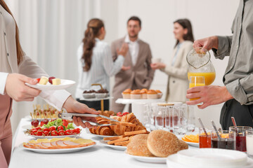 Coworkers having business lunch in restaurant, closeup - Powered by Adobe