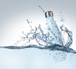 Bottle of water and splashes on light background