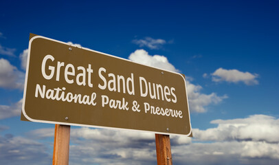 Great Sand Dunes National Park and Preserve (Colorado) Road Sign Against Blue Sky and Clouds.