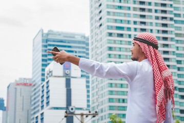 Backside Islamic man wear formal muslim dress in modern uae city. Arab men traditional hijab...