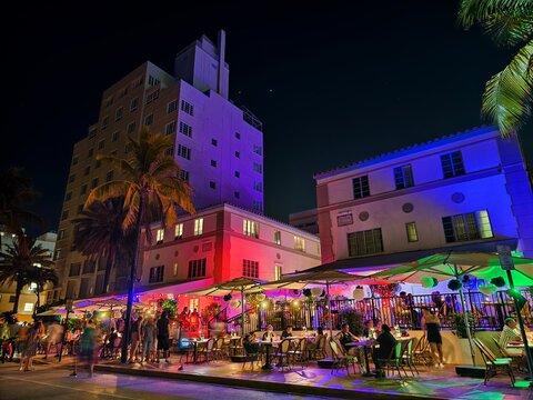 Miami Beach, Florida - July 8, 2024: Art Deco buildings lit up at night on Ocean Drive in South Beach.