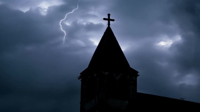 The striking silhouette of a church bell tower against a dramatic stormy sky.
