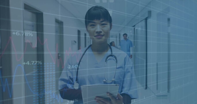 Image of financial data processing over biracial female doctor in hospital