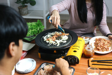 Holding Beef Slice Using Clamp Tool While CookingTogether With Onion Using Chopstick