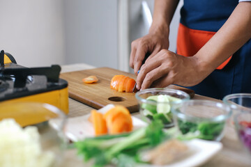 Man Hands Slicing The Tomatoes On Wooden Board. Slicing Ingredients To Make Indonesian Chicken Soup