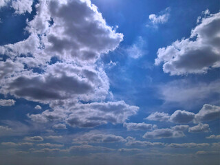 Blue Sky with Large White Clouds Partially Shaded from Below