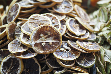 Detailed closeup of dehydrated citrus slices on display in a vibrant market setting