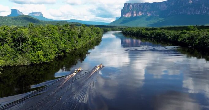 Tourists In Longboats Touring On Churun River To Angel Falls In Canaima National Park, Venezuela. ascending drone shot