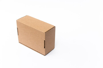 A small, plain cardboard box with a simple design, resting on a clean white surface. Perfect for shipping, storage, or packaging small items securely and efficiently.