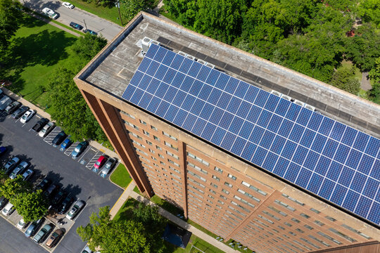Photovoltaic panels for producing clean ecological electric energy. Residential apartment building with solar roof. Renewable electricity with zero emission concept