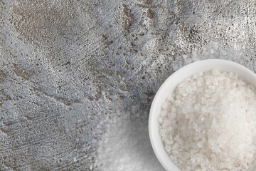 Salt shaker white spilled salt pile on desk