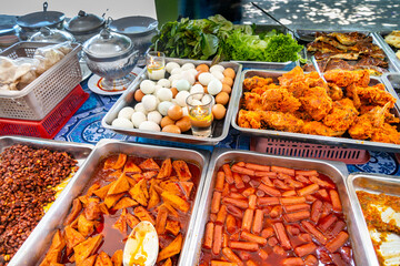 Large variety of Malaysian buffet foods,ready to eat and displayed in various steel trays,Langkawi Island,Malaysia.