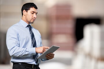 Portrait of warehouseman checking delivery in warehouse.