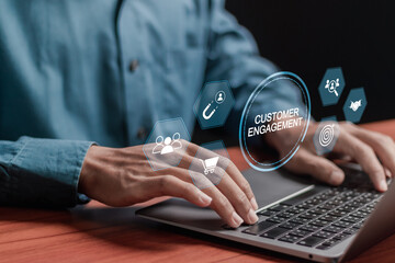 Fototapeta premium Customer engagement concept. Target customer, buyer persona and customer behavior. Businessman using laptop with customer engagement icons on virtual screen.