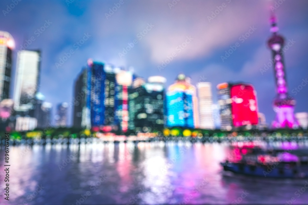 Aufkleber a blurry night view of a city skyline reflecting in the water. the tall buildings are brightly lit, 
