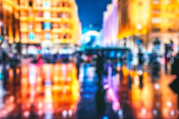 Fototapeta premium Blurry abstract photo of a city at night with colorful lights reflecting off a wet street.