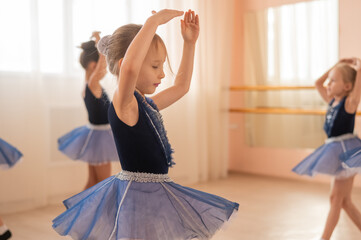 Little ballerinas perform at a dance school. 