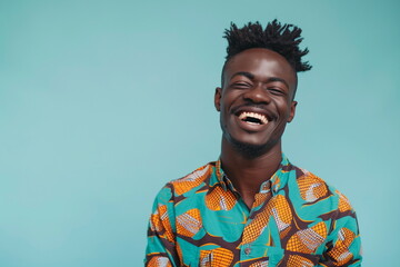 Obraz premium Confident African black man standing in studio against blue background and smiling broadly. Copy space.