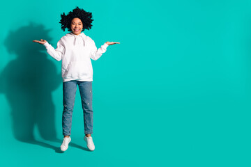 Photo portrait of young funny chevelure hairstyle lady holding two arms compare shopping offers isolated on aquamarine color background